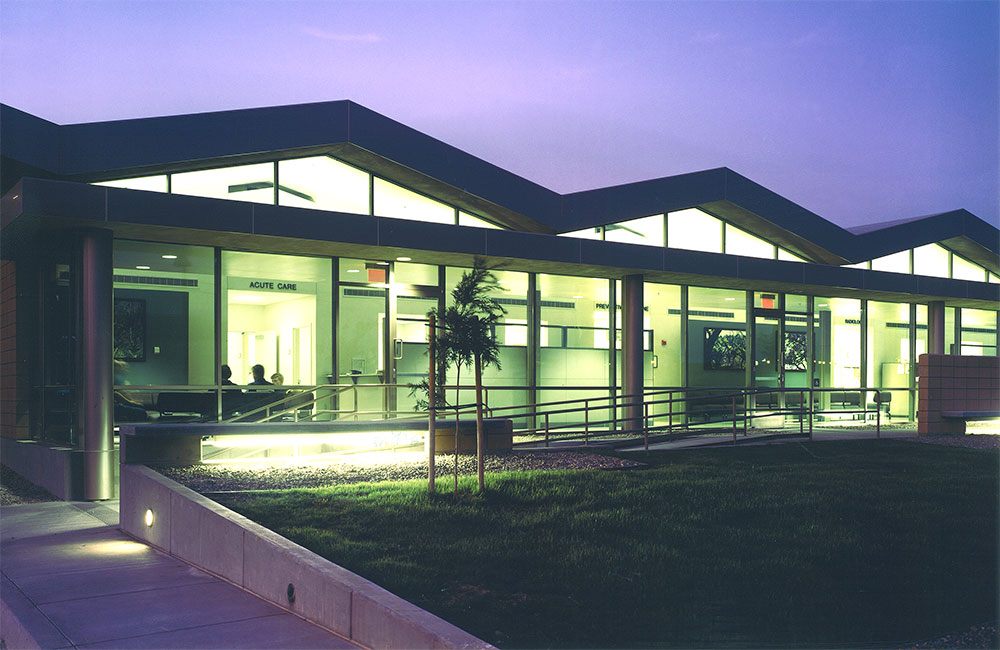 Image 6. Building exterior at dusk. A warm glow emanates from interior lighting.