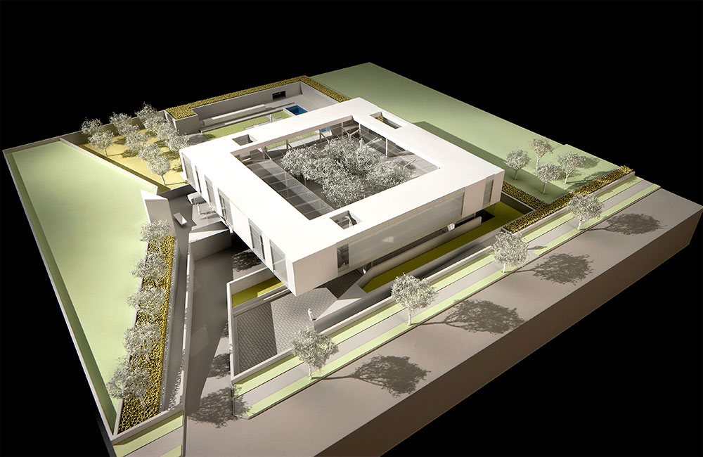 Image 4. Corner view of model showing a 2-story modern square shaped residence with a central courtyard.