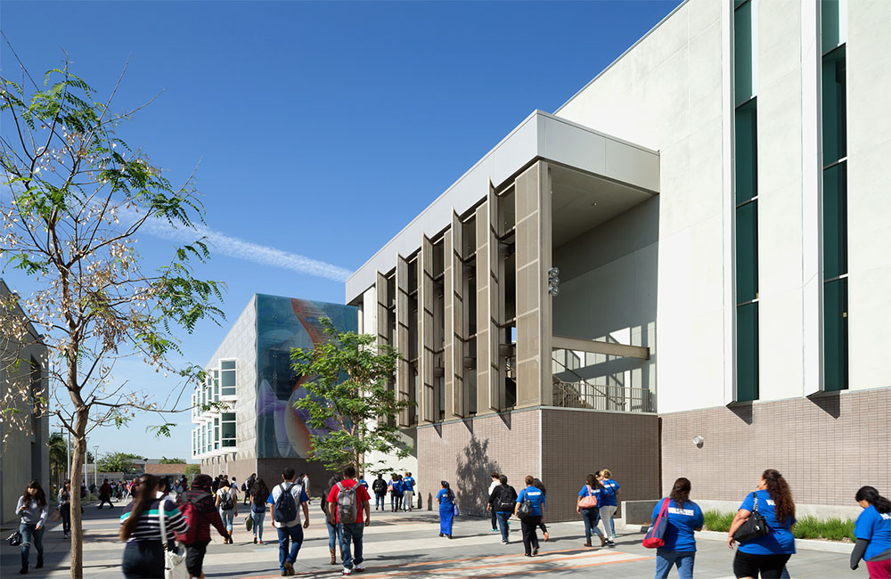 Image 4. Exterior side view of the building showing vertical sunshade panels in the foreground.